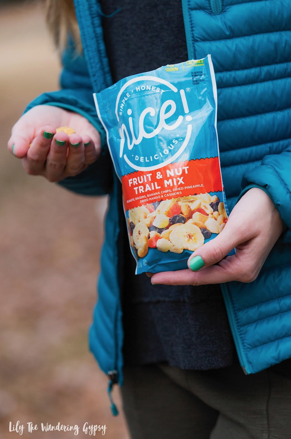 Influencer holding a bag of Nice! brand fruit and nut trail mix